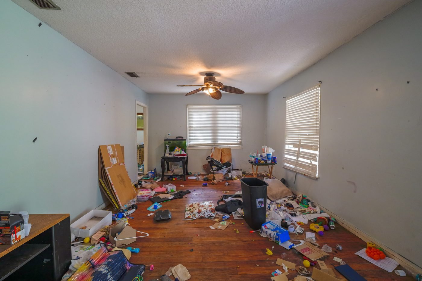 Cluttered living room before renovation